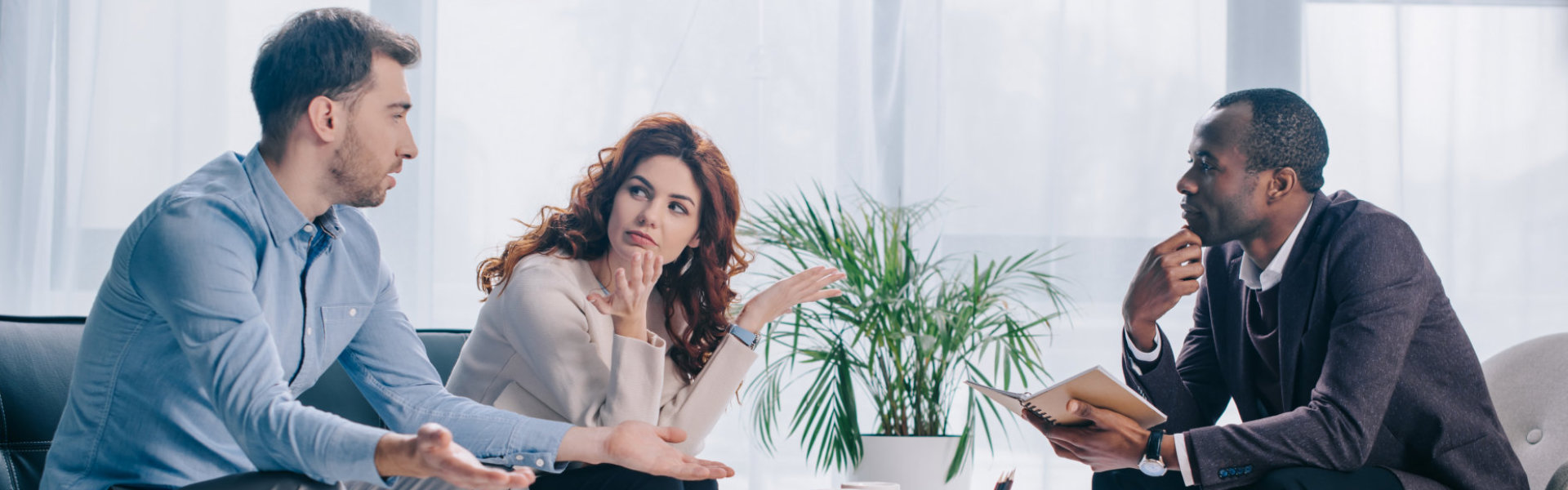 Quarreling couple talking to psychiatrist in office