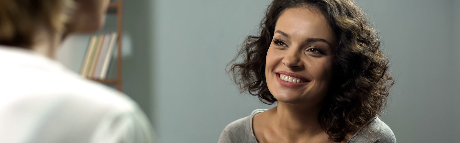 Young smiling lady at rehab therapy session, help from psychologist, improvement, stock photo